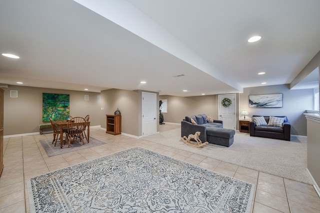 living area featuring recessed lighting, baseboards, light carpet, and light tile patterned flooring