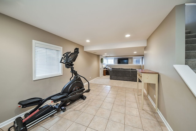 workout room featuring light tile patterned floors, recessed lighting, and baseboards