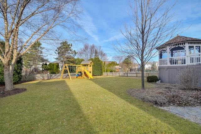 view of yard with a playground and a fenced backyard