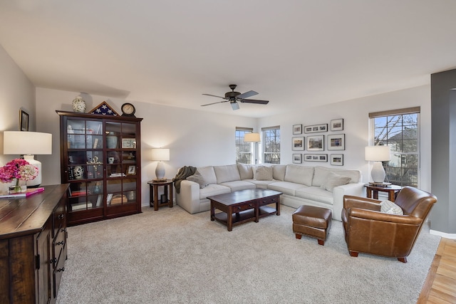 living room featuring baseboards and ceiling fan