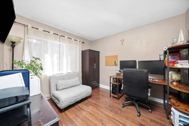 office space with baseboards and wood finished floors