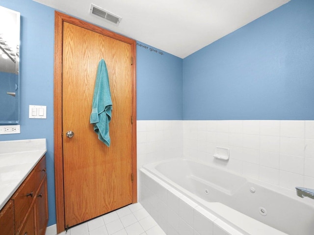 bathroom featuring tile patterned flooring, visible vents, vanity, and a whirlpool tub