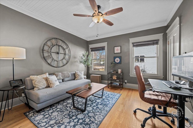 office space with radiator, wood finished floors, baseboards, and ornamental molding