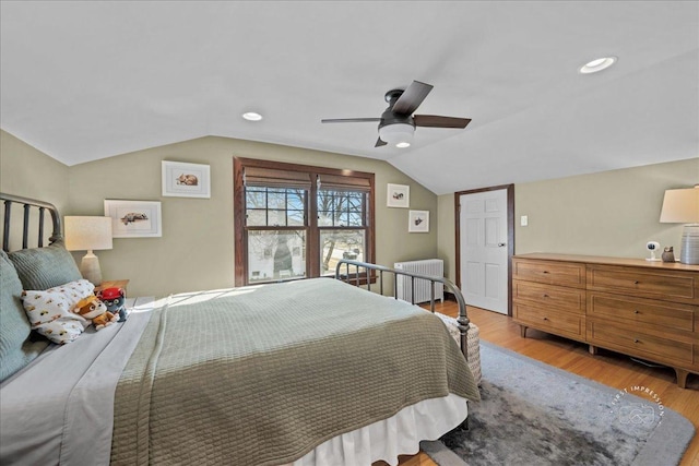 bedroom featuring a ceiling fan, wood finished floors, recessed lighting, radiator, and vaulted ceiling