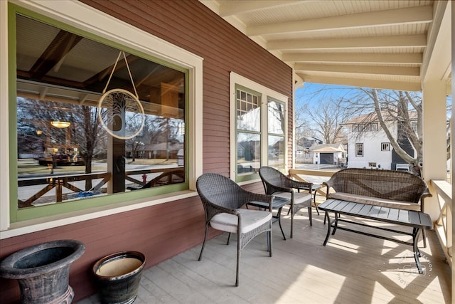 sunroom featuring lofted ceiling with beams