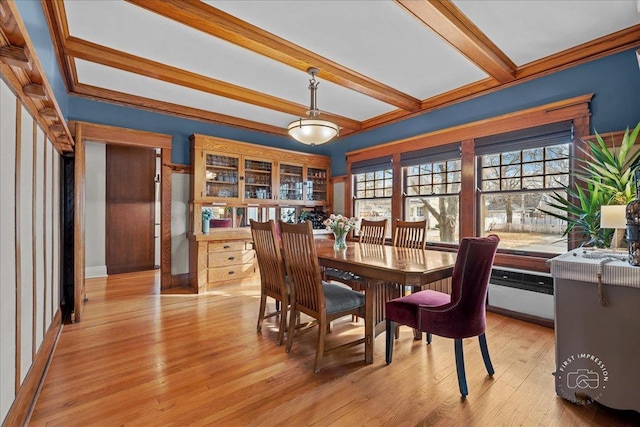 dining room featuring beamed ceiling and light wood-style floors