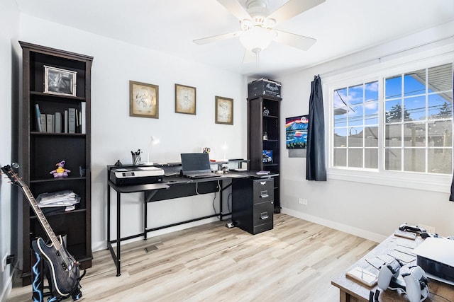 home office with baseboards, light wood-type flooring, and a ceiling fan