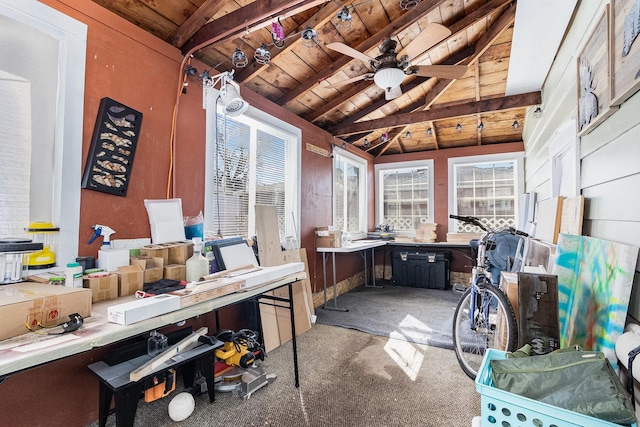 sunroom / solarium featuring wooden ceiling, vaulted ceiling with beams, and a ceiling fan