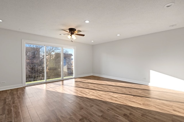 unfurnished room featuring baseboards, a ceiling fan, wood finished floors, a textured ceiling, and recessed lighting