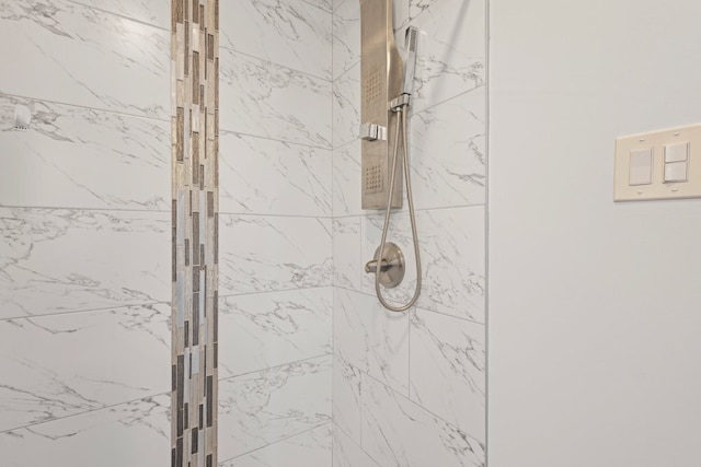 bathroom with a tile shower