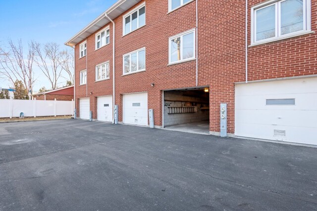 exterior space with brick siding and fence