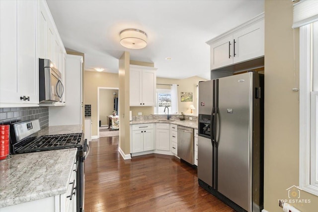 kitchen featuring white cabinets, dark wood-style flooring, appliances with stainless steel finishes, and a sink