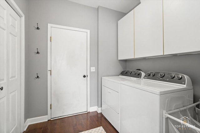 laundry room featuring baseboards, cabinet space, dark wood-type flooring, and washer and clothes dryer