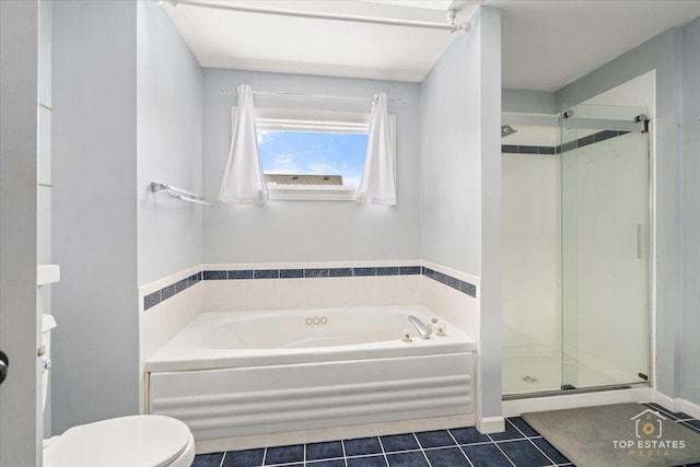 bathroom featuring tile patterned floors, a shower stall, toilet, and a bath