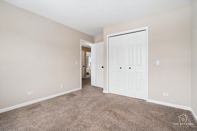 unfurnished bedroom with a closet, baseboards, and carpet floors