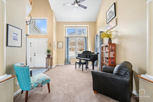 sitting room with baseboards, ceiling fan, high vaulted ceiling, and carpet