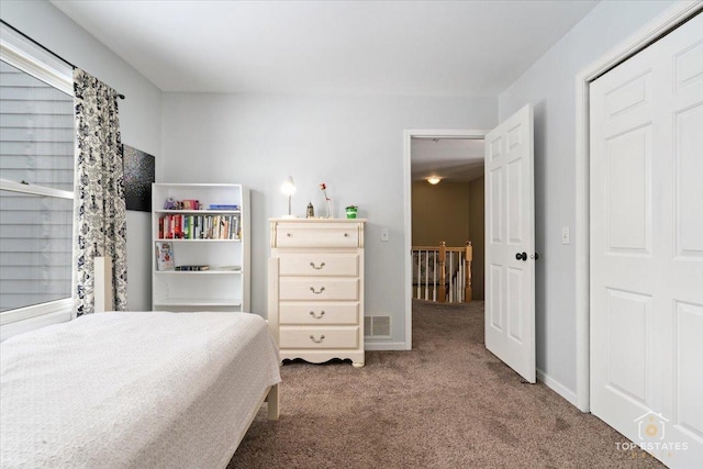 carpeted bedroom featuring visible vents and baseboards