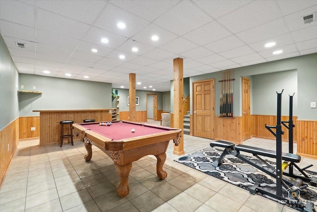 rec room with a wainscoted wall, visible vents, and wood walls