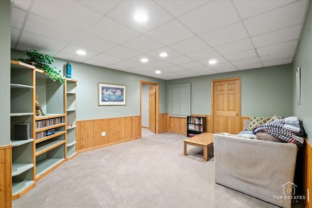 carpeted living room featuring recessed lighting, a wainscoted wall, wood walls, and a paneled ceiling