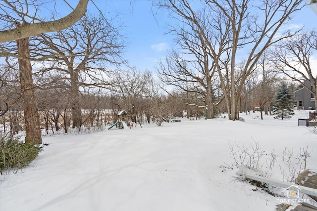 yard layered in snow with playground community