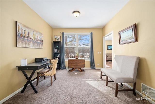 carpeted office space with visible vents and baseboards