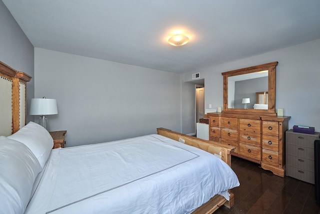 bedroom with visible vents and dark wood-style flooring