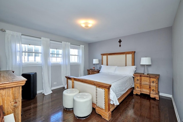 bedroom with dark wood finished floors and baseboards