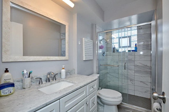 full bathroom with a shower stall, toilet, and vanity