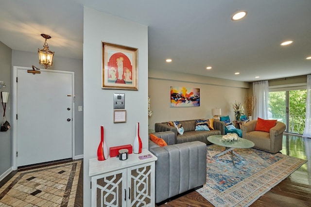 living room featuring baseboards, wood finished floors, and recessed lighting