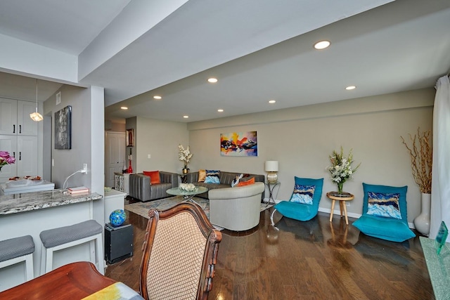 living area with recessed lighting, baseboards, and wood finished floors