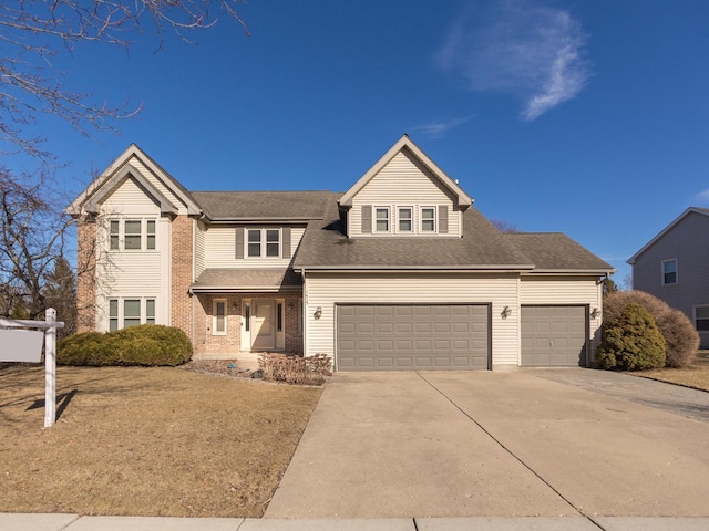 traditional-style home featuring a garage, driveway, and brick siding