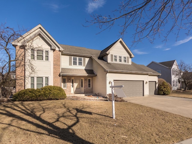 view of front facade featuring driveway, brick siding, an attached garage, and a front yard