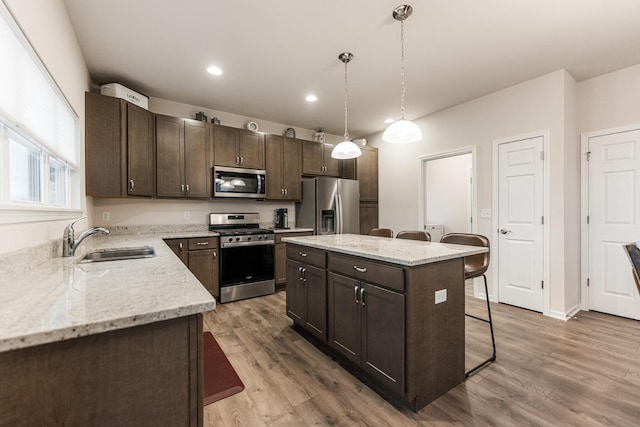 1125 Juniper Dr, Sycamore, IL 60178 - kitchen with stainless steel appliances, a sink, dark brown cabinets, light wood-type flooring, and recessed lighting