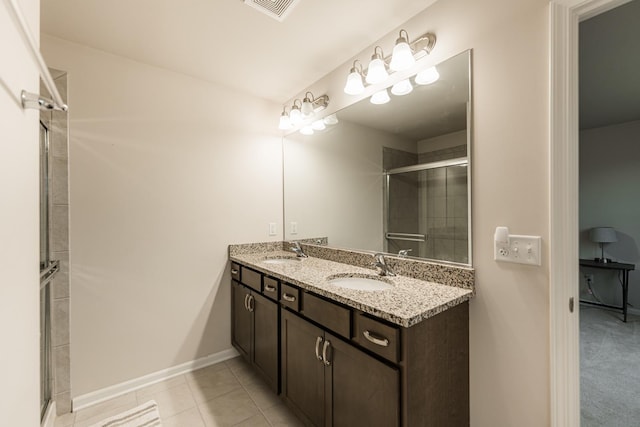 1125 Juniper Dr, Sycamore, IL 60178 - bathroom featuring a stall shower, double vanity, baseboards, and tile patterned flooring