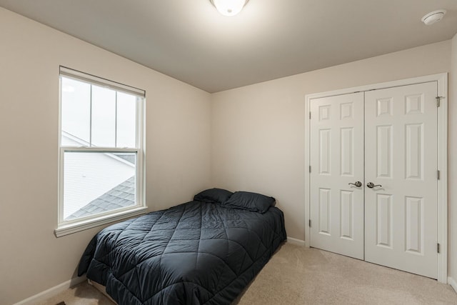 1125 Juniper Dr, Sycamore, IL 60178 - bedroom with light carpet, baseboards, and a closet