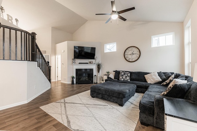 1125 Juniper Dr, Sycamore, IL 60178 - living area featuring high vaulted ceiling, ceiling fan, stairs, healthy amount of natural light, and wood finished floors