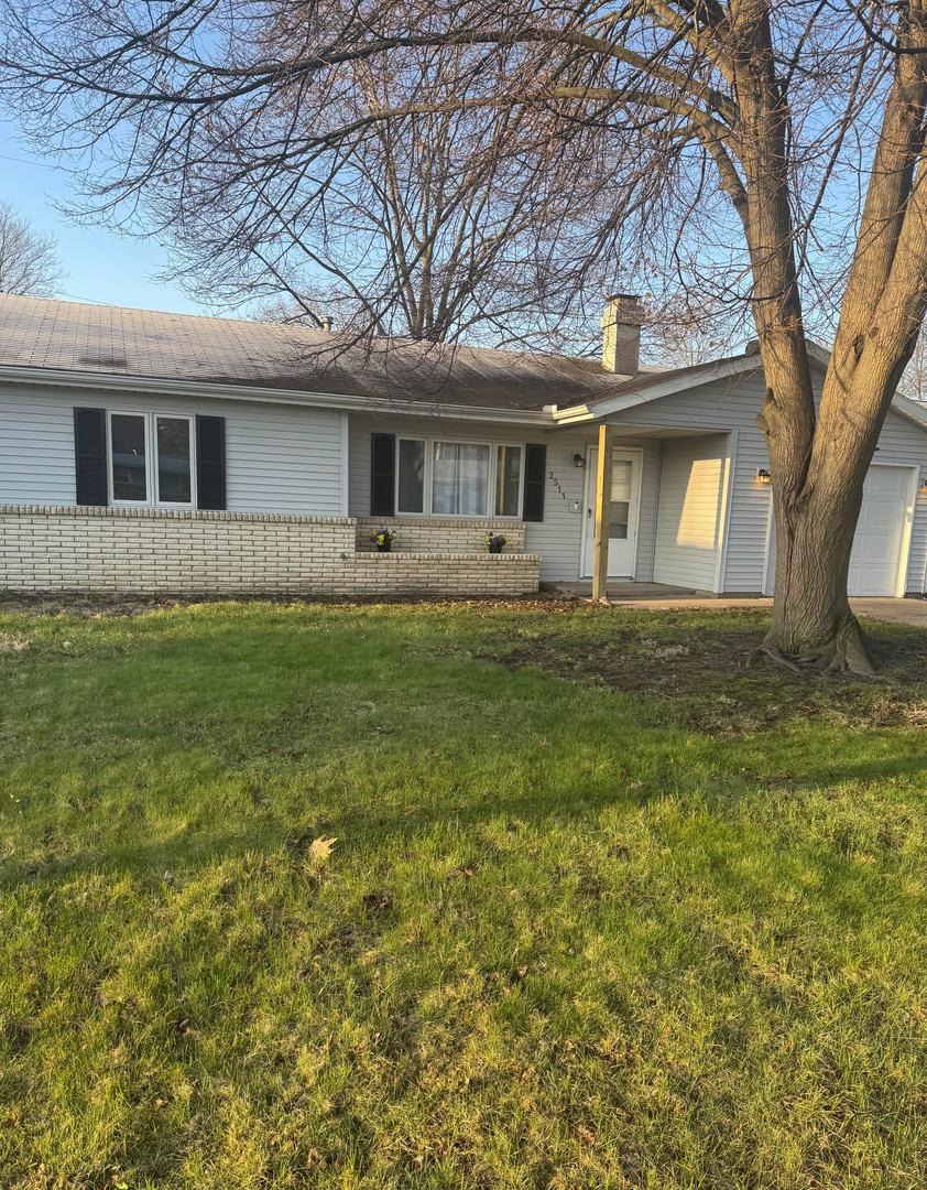 2511 Trafalgar Sq, Champaign, IL 61821 - single story home with brick siding, a front lawn, a garage, and a chimney