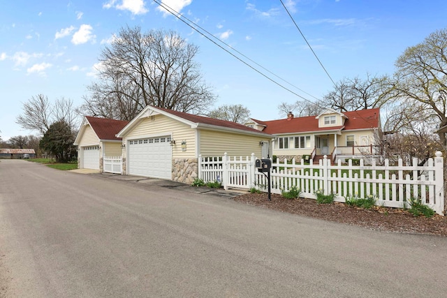 2115 N Woodlawn Park Ave, Mchenry, IL 60051 - exterior space with a garage, an outbuilding, and a fenced front yard