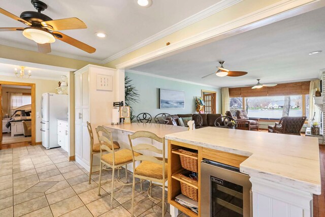 2115 N Woodlawn Park Ave, Mchenry, IL 60051 - kitchen featuring freestanding refrigerator, ceiling fan, light tile patterned flooring, beverage cooler, and open floor plan