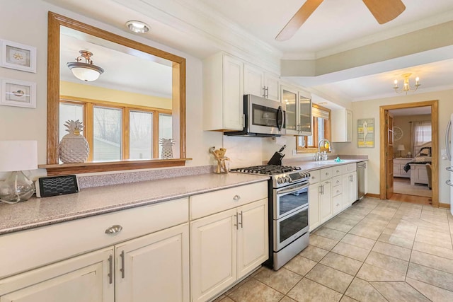 2115 N Woodlawn Park Ave, Mchenry, IL 60051 - kitchen featuring white cabinets, light countertops, crown molding, and appliances with stainless steel finishes