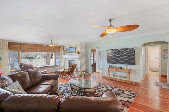 2115 N Woodlawn Park Ave, Mchenry, IL 60051 - living area featuring arched walkways, ceiling fan, crown molding, and a wealth of natural light