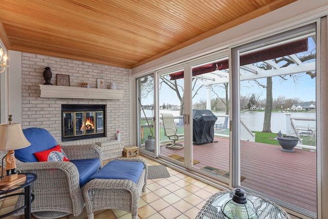 2115 N Woodlawn Park Ave, Mchenry, IL 60051 - sunroom featuring a water view and a brick fireplace