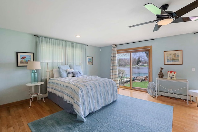 2115 N Woodlawn Park Ave, Mchenry, IL 60051 - bedroom featuring access to outside, wood finished floors, a baseboard radiator, and a water view