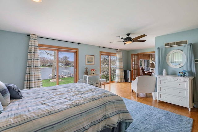 2115 N Woodlawn Park Ave, Mchenry, IL 60051 - bedroom featuring a ceiling fan, visible vents, access to exterior, a water view, and wood finished floors