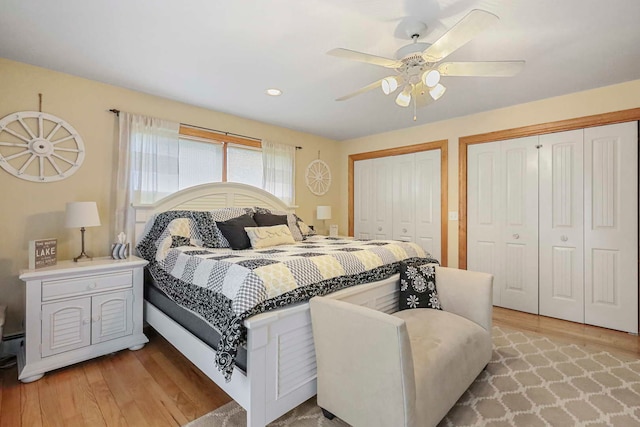 2115 N Woodlawn Park Ave, Mchenry, IL 60051 - bedroom featuring light wood-style floors, a ceiling fan, and multiple closets