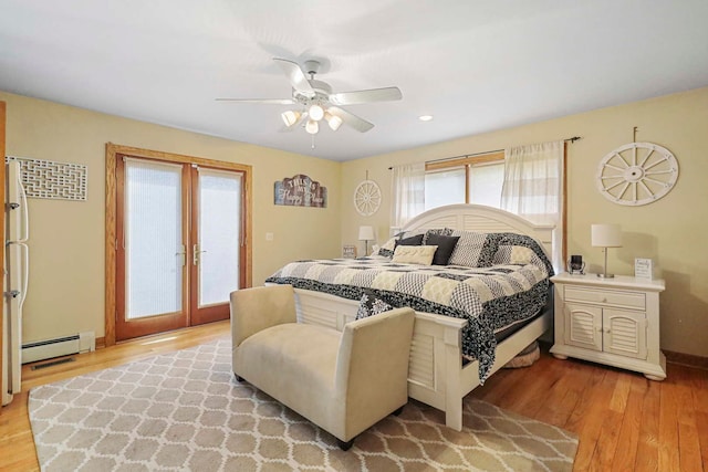 2115 N Woodlawn Park Ave, Mchenry, IL 60051 - bedroom with french doors, a baseboard radiator, light wood-type flooring, and multiple windows