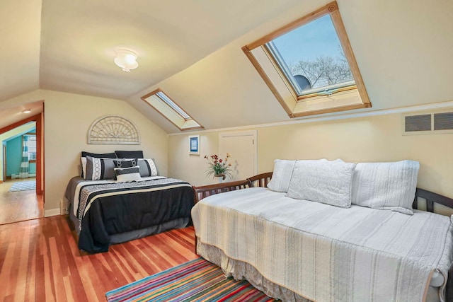 2115 N Woodlawn Park Ave, Mchenry, IL 60051 - bedroom featuring vaulted ceiling with skylight, wood finished floors, and visible vents