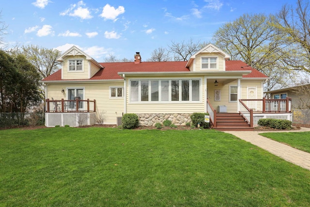 2115 N Woodlawn Park Ave, Mchenry, IL 60051 - exterior space featuring roof with shingles, a chimney, a wooden deck, and a front yard