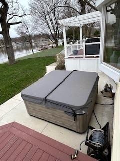 2115 N Woodlawn Park Ave, Mchenry, IL 60051 - wooden deck featuring a water view, a hot tub, and a lawn