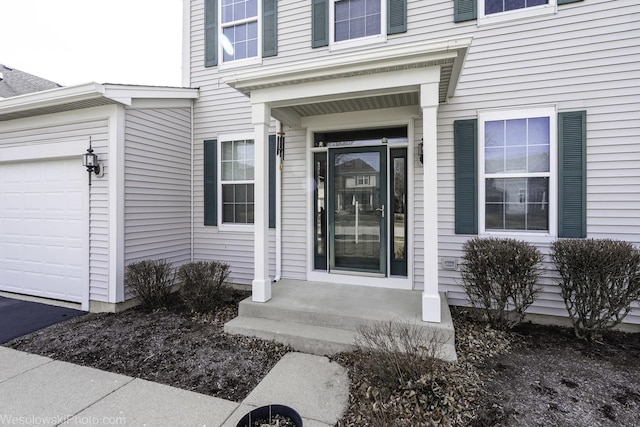 property entrance featuring an attached garage